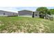 Discover a tranquil backyard showcasing a modern gray home exterior, ready for outdoor relaxation and entertainment at 8857 Highpoint Blvd, Brooksville, FL 34613