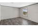 Bedroom with hardwood floors and a large window providing a view of the neighborhood at 8857 Highpoint Blvd, Brooksville, FL 34613