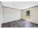 Bedroom features wood-look floors, natural light, and light-colored walls at 8857 Highpoint Blvd, Brooksville, FL 34613