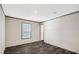 The bedroom features vinyl floors, light walls, and a window with a yard view at 8857 Highpoint Blvd, Brooksville, FL 34613