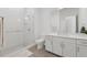 Clean, modern bathroom featuring a glass-enclosed shower, white vanity, and neutral tile flooring at 920 N Osceola Ave # 803, Clearwater, FL 33755