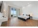 Cozy bedroom offering water views, herringbone wood floors, and access to a balcony at 920 N Osceola Ave # 803, Clearwater, FL 33755