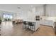 Modern, open-concept kitchen with stainless steel appliances, an island, and dining area at 920 N Osceola Ave # 803, Clearwater, FL 33755
