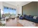 Bright living room boasts floor-to-ceiling windows with stunning water views, modern lighting, and a comfortable seating area at 920 N Osceola Ave # 803, Clearwater, FL 33755