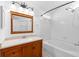 Bright bathroom offers a tub and a wood vanity with ample lighting at 754 Cape Cod Cir, Valrico, FL 33594