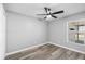 Bright bedroom with wood-look floors, ceiling fan, and fresh paint at 754 Cape Cod Cir, Valrico, FL 33594