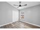 Bright bedroom with wood-look floors, ceiling fan, and closet with white doors at 754 Cape Cod Cir, Valrico, FL 33594