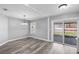Open dining area with new gray laminate flooring and access to the backyard at 754 Cape Cod Cir, Valrico, FL 33594