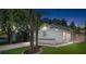 Charming home with a manicured lawn, decorative front, and a well-lit exterior, perfect for evening enjoyment at 754 Cape Cod Cir, Valrico, FL 33594