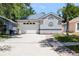Front exterior featuring a well-maintained lawn, a two car garage and a driveway, highlighting suburban comfort at 754 Cape Cod Cir, Valrico, FL 33594