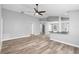Spacious living room featuring modern gray tones, a ceiling fan, and contemporary flooring at 754 Cape Cod Cir, Valrico, FL 33594