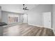 Bright living room with sleek flooring, a ceiling fan, and a view towards the front door at 754 Cape Cod Cir, Valrico, FL 33594