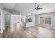 Open-concept living space with gray walls, modern flooring, and sightlines into the kitchen and dining areas at 754 Cape Cod Cir, Valrico, FL 33594