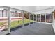 Screened patio featuring carpet and access to a green, landscaped backyard at 754 Cape Cod Cir, Valrico, FL 33594