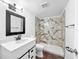 Modern bathroom featuring stylish marble tile in shower and vanity with ample storage at 8608 Huron Ct # 57, Tampa, FL 33614