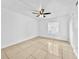 Bright bedroom featuring a ceiling fan, tile flooring, and a window at 8608 Huron Ct # 57, Tampa, FL 33614