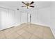 Spacious bedroom with a ceiling fan, tile floors, and ample closet space at 8608 Huron Ct # 57, Tampa, FL 33614