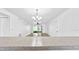 Open-concept living room with tile flooring, modern light fixture, and a bar into the kitchen at 8608 Huron Ct # 57, Tampa, FL 33614