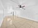 Open concept living space with tile floors, ceiling fan, and view into kitchen at 8608 Huron Ct # 57, Tampa, FL 33614
