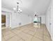 Spacious living room with tile floors, ceiling fan, and sliding glass doors to the outside at 8608 Huron Ct # 57, Tampa, FL 33614