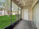 View from screened-in patio overlooking the lawn and landscape at 8608 Huron Ct # 57, Tampa, FL 33614