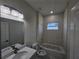 Clean bathroom featuring a single sink vanity and a shower-tub combo and a window at 2310 Logsdon St, North Port, FL 34287