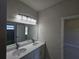 Clean bathroom featuring double sinks and a window at 2310 Logsdon St, North Port, FL 34287