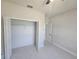 Bedroom with neutral paint, tile floors, closet and access to the bathroom at 2310 Logsdon St, North Port, FL 34287