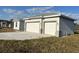 Well-maintained home featuring a large driveway and attached two-car garage at 2310 Logsdon St, North Port, FL 34287