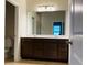 Bathroom featuring double sink vanity, large mirror, and tile floors at 29307 Meadowcroft Ave, Wesley Chapel, FL 33544