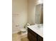 Bathroom with vanity, sink, mirror, toilet, and tile flooring at 29307 Meadowcroft Ave, Wesley Chapel, FL 33544