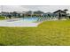 Community pool area with lounge chairs, tables, and nearby homes at 29307 Meadowcroft Ave, Wesley Chapel, FL 33544