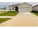 Charming single-story home featuring a well-manicured lawn and attached two-car garage at 29307 Meadowcroft Ave, Wesley Chapel, FL 33544