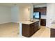 Kitchen island with granite countertop and stainless steel sink at 29307 Meadowcroft Ave, Wesley Chapel, FL 33544