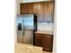 Kitchen with stainless steel refrigerator and granite countertops at 29307 Meadowcroft Ave, Wesley Chapel, FL 33544
