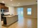 Open kitchen with granite countertops and stainless steel appliances at 29307 Meadowcroft Ave, Wesley Chapel, FL 33544