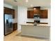 Bright kitchen with stainless steel appliances, granite countertops, and dark wood cabinets at 29307 Meadowcroft Ave, Wesley Chapel, FL 33544