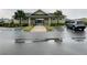 Pool with covered entrance and a neatly landscaped parking area at 29307 Meadowcroft Ave, Wesley Chapel, FL 33544