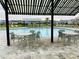 Community pool area with tables and seating under striped awnings at 29307 Meadowcroft Ave, Wesley Chapel, FL 33544