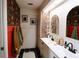 A cozy bathroom with double sinks and decorative wallpaper at 4217 Avanti Cir, New Port Richey, FL 34655