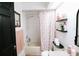 Bathroom featuring a tub with a shower, floral shower curtain, and updated fixtures at 4217 Avanti Cir, New Port Richey, FL 34655
