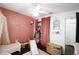 Bright bedroom with pink accent wall, custom name decoration, walk-in closet, and cozy details at 4217 Avanti Cir, New Port Richey, FL 34655