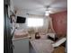 Bedroom features a pink accent wall, play area, canopy bed, television and lots of natural light at 4217 Avanti Cir, New Port Richey, FL 34655