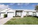 Charming home featuring a well-manicured lawn and inviting entry with cozy outdoor seating at 4217 Avanti Cir, New Port Richey, FL 34655