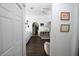 Inviting hallway features a view into the living room, dark floors, and white trim at 4217 Avanti Cir, New Port Richey, FL 34655
