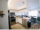 Modern kitchen features stainless appliances, butcher block counters and open dining area at 4217 Avanti Cir, New Port Richey, FL 34655