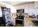 Kitchen features stainless appliances, black oven and fridge with Gathering photos at 4217 Avanti Cir, New Port Richey, FL 34655