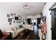 Bright living room featuring a large sectional couch, dark floors, and sliding barn door at 4217 Avanti Cir, New Port Richey, FL 34655