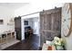 View of office with two modern barn doors, computer setup and hardwood floors at 4217 Avanti Cir, New Port Richey, FL 34655