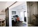 Office view with barn door, computer setup and black front door at 4217 Avanti Cir, New Port Richey, FL 34655